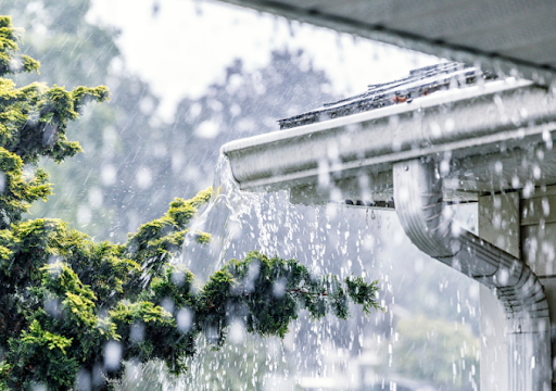 A gutter overflowing with rain water